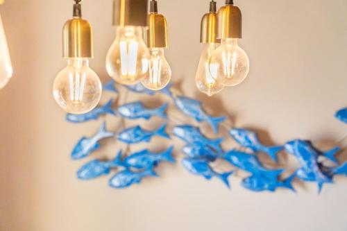 a group of blue glass lights hanging from a wall at Villa Konstantina Lulas Penthouse in Petrití