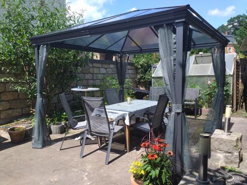 a gazebo with a table and chairs under it at Ferienwohnungen am Hauptplatz in Pirna