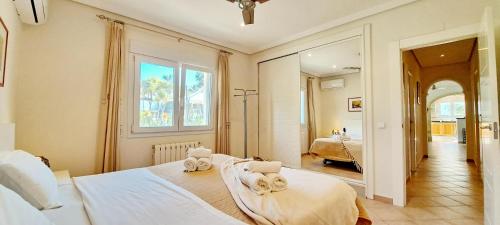 a bedroom with two beds with towels on them at Villa Sollero by Solidays in Moraira