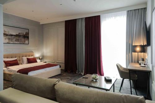 President Hotel&Restaurant&SPA tesisinde bir odada yatak veya yataklar