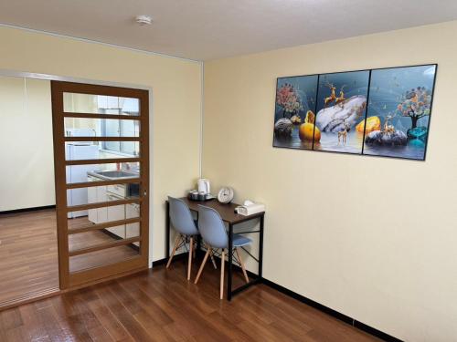 a room with a table and a painting on the wall at OKAERI築地町 in Takamatsu