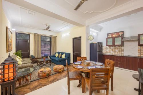 a kitchen and living room with a table and chairs at Mountain Crest Kasauli I 2 Bhk Service Apartment I Kasauli in Kasauli