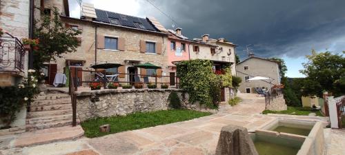 a group of buildings with a patio and a courtyard at Malga Laben in Velo Veronese