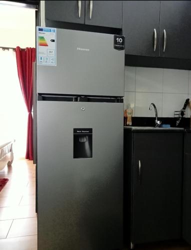 a stainless steel refrigerator in a kitchen at Riverside Apartments in Buwate