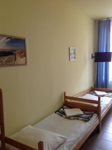 2 łóżka pojedyncze w pokoju z oknem w obiekcie Ośrodek Wczasowy Akacja w Dźwirzynie