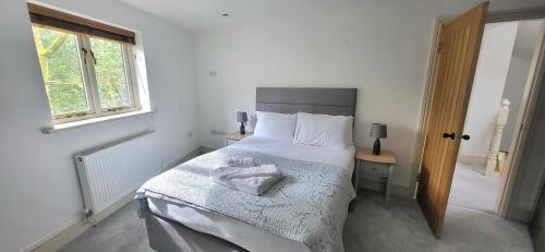 a bedroom with a bed with a towel on it at Woodlands in Windermere