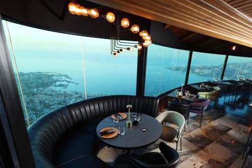 a restaurant with tables and chairs and a view at Bay Lodge Boutique Hotel in Jounieh