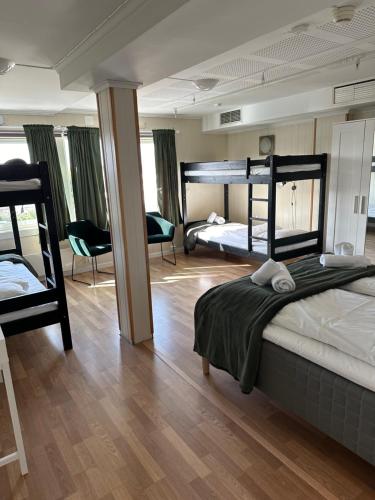 a bedroom with two bunk beds and a living room at Tune Hotell Sarpsborg in Sarpsborg