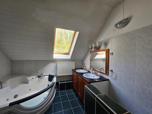 a bathroom with a tub and a sink and a bath tub at Never Say Never Vendégház 