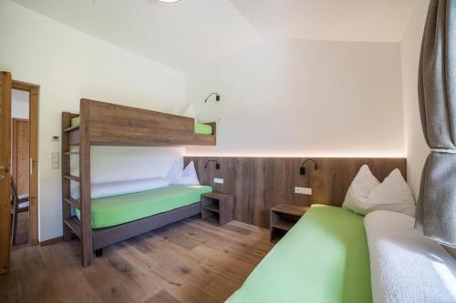 a small room with a bunk bed and a couch at Flatschhof - Apartment Cevedale in Castelbello-ciardes