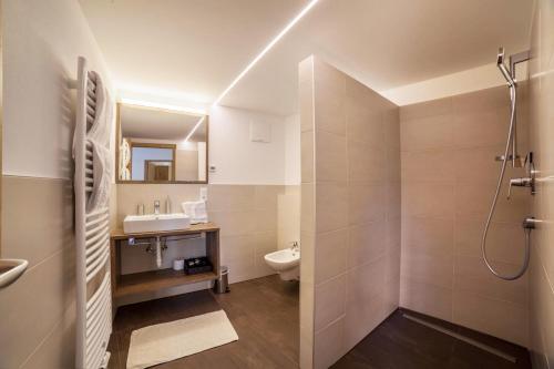 a bathroom with a shower and a sink and a toilet at Flatschhof - Apartment Cevedale in Kastelbell-Tschars