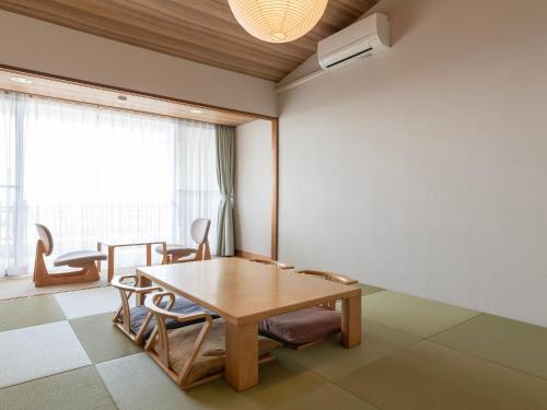 a dining room with a table and chairs at The Day Osaka in Osaka