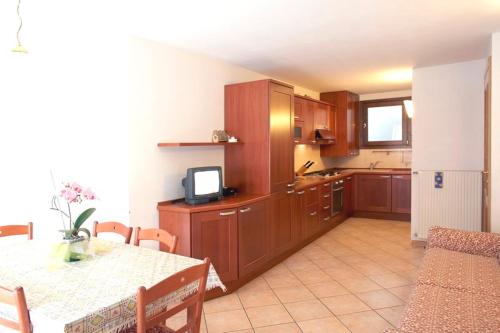 a kitchen with a table and a dining room at Appartamenti Home Service in Arabba