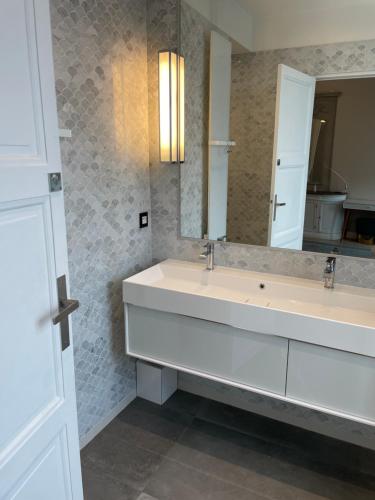 a bathroom with a sink and a mirror at Luxury apartment Times Square district in Paris