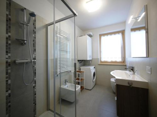 a bathroom with a shower and a toilet and a sink at Appartamenti Home Service in Arabba