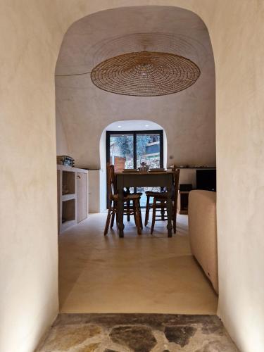 a dining room with a table and a chandelier at Torre degli Svizzeri in Civezza