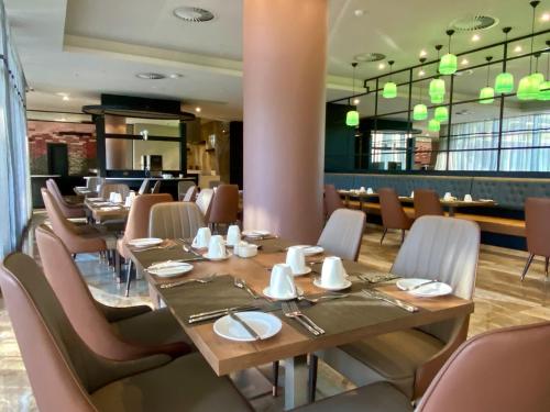 a dining room with a table and chairs at Coastlands Skye Hotel, Ridgeside, Umhlanga in Durban