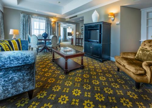 a living room with a couch and a table at Hemingways Hotel in East London