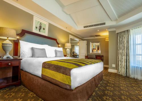 a hotel room with a large bed and a window at Hemingways Hotel in East London