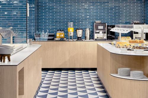 a restaurant with a counter with plates of food at Exe Portals Nous in Portals Nous