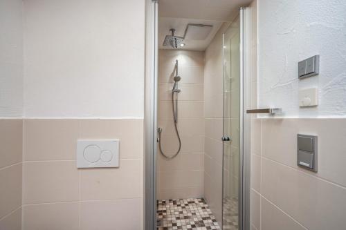 a bathroom with a shower and a glass door at Appartement Braun 1 in Bolsterlang
