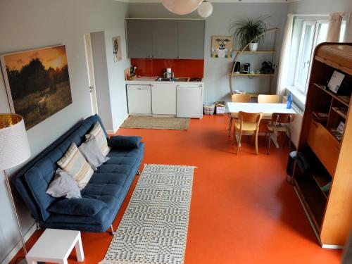 a living room with a blue couch and a table at Cozy Place in Müllendorf
