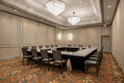 a conference room with a large table and chairs at Holiday Inn Winnipeg-South by IHG in Winnipeg