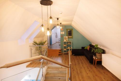 a room with a staircase and a living room at Dunakavics XIII Apartman in Szentendre