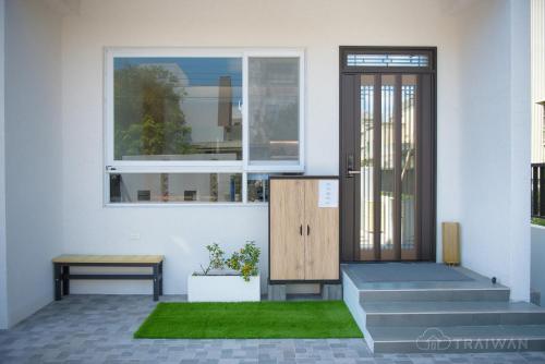 a front door of a house with stairs and a window at Ying Yue Homestay 台東縣登記民宿2029號 in Taitung City