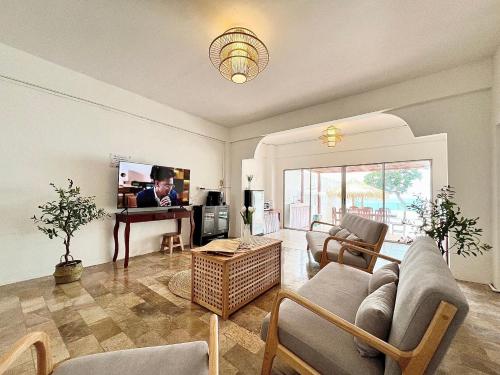 a living room with a couch and a tv at Gao Bayview Banchang in Rayong