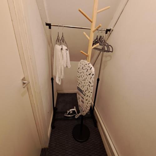 a hallway with hangers and shoes in a room at Family-friendly Studio flat in Dagenham in Dagenham