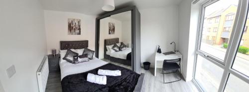 a bedroom with a bed and a mirror at SAV Apartments Loughborough - 1 Bed Flat in Loughborough