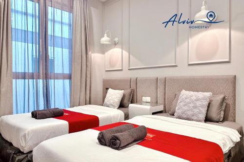 a hotel room with two beds with red and white sheets at NEW! The Shore Residences 3BR Luxury I Direct access to Shopping I 6-10pax I 10minsJonker in Malacca