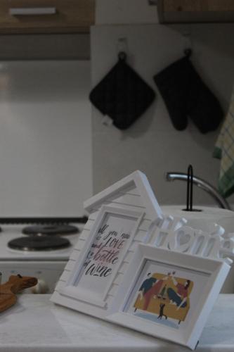 a kitchen counter with a sink and a picture on it at Milan's Apartment in Skopje
