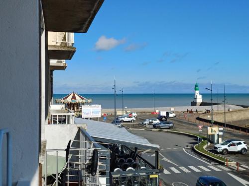 a view of the beach from a balcony of a building at Balcon face à la mer in Le Tréport