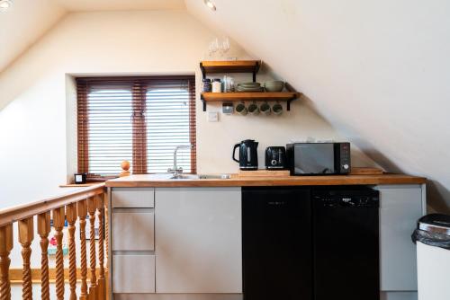 a kitchen with a sink and a counter top at Silverwood Loft in Telford