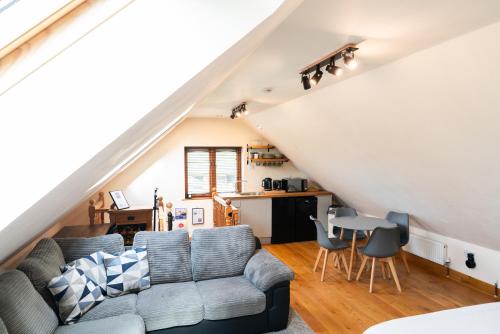 a living room with a couch and a table at Silverwood Loft in Telford