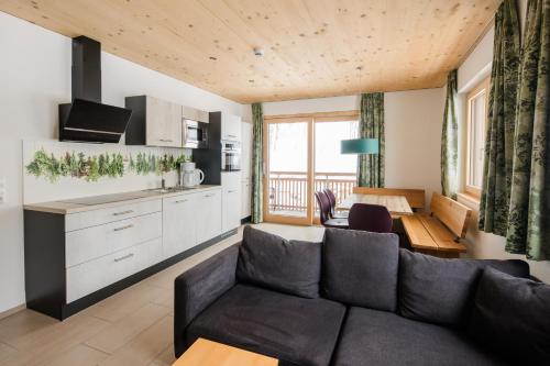a living room with a couch and a table at Lisas Schröcken in Schröcken