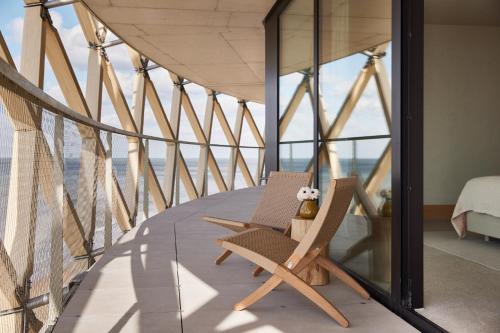 a room with two chairs on a balcony at C-Hotels Silt in Middelkerke