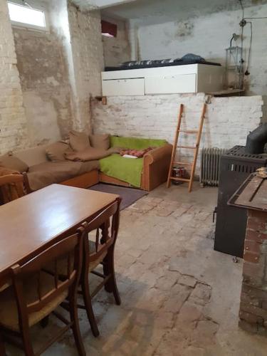 a living room with a couch and a table at Central Industrial Souterrain in Vienna