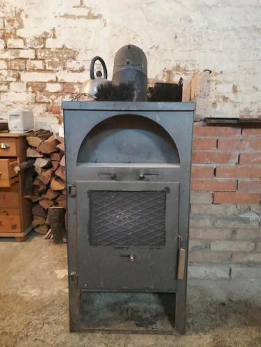 an old stone oven in a room with a brick wall at Central Industrial Souterrain in Vienna