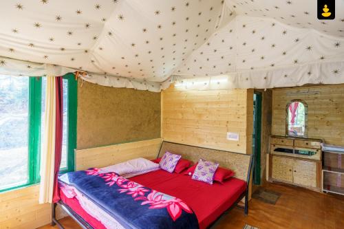 a bed in a tent in a room at The Monk Campsite by Livingstone in Kalpa