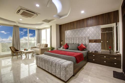 a bedroom with a large bed and a large window at SONESTA LUXURY APARTMENT in New Delhi