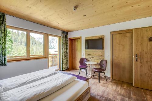 a bedroom with a bed and a table and chairs at Lisas Schröcken in Schröcken