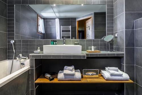 a bathroom with a sink and a mirror at Chalet Hotel Kaya in Les Menuires