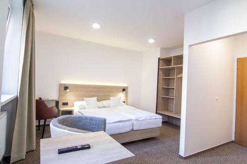 a hotel room with a bed and a desk at Hotel Avion in Prague