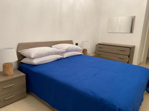 a bedroom with a blue bed with two night stands at Poesia di Lerici in Lerici