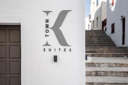 a building with a sign on the side of a door at K Town Suites Naxos in Naxos Chora