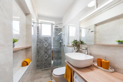 a bathroom with a sink and a shower at Apartments Relax in Rovinj