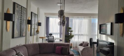uma sala de estar com um sofá e uma cadeira em Bordó apartmán A4 v Chomutově em Chomutov
